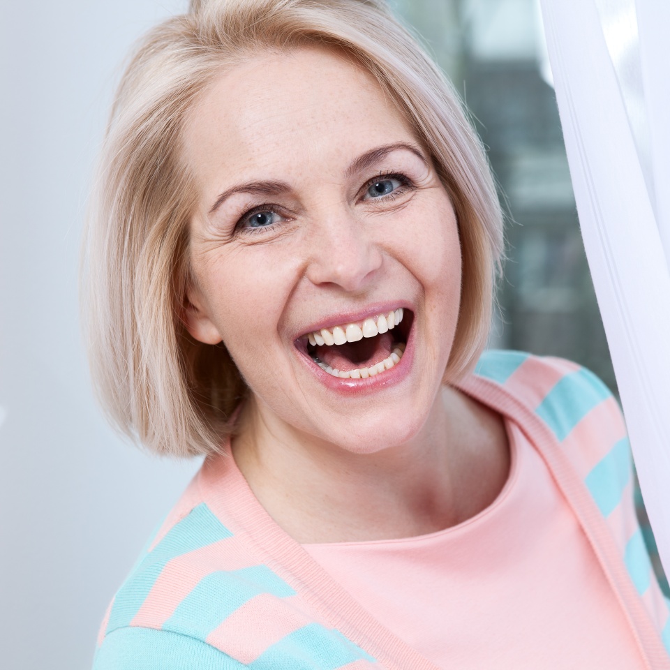 Attractive middle aged woman relaxing at home. The beautiful face close up.