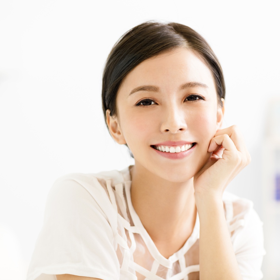 closeup smiling young asian woman face in living room