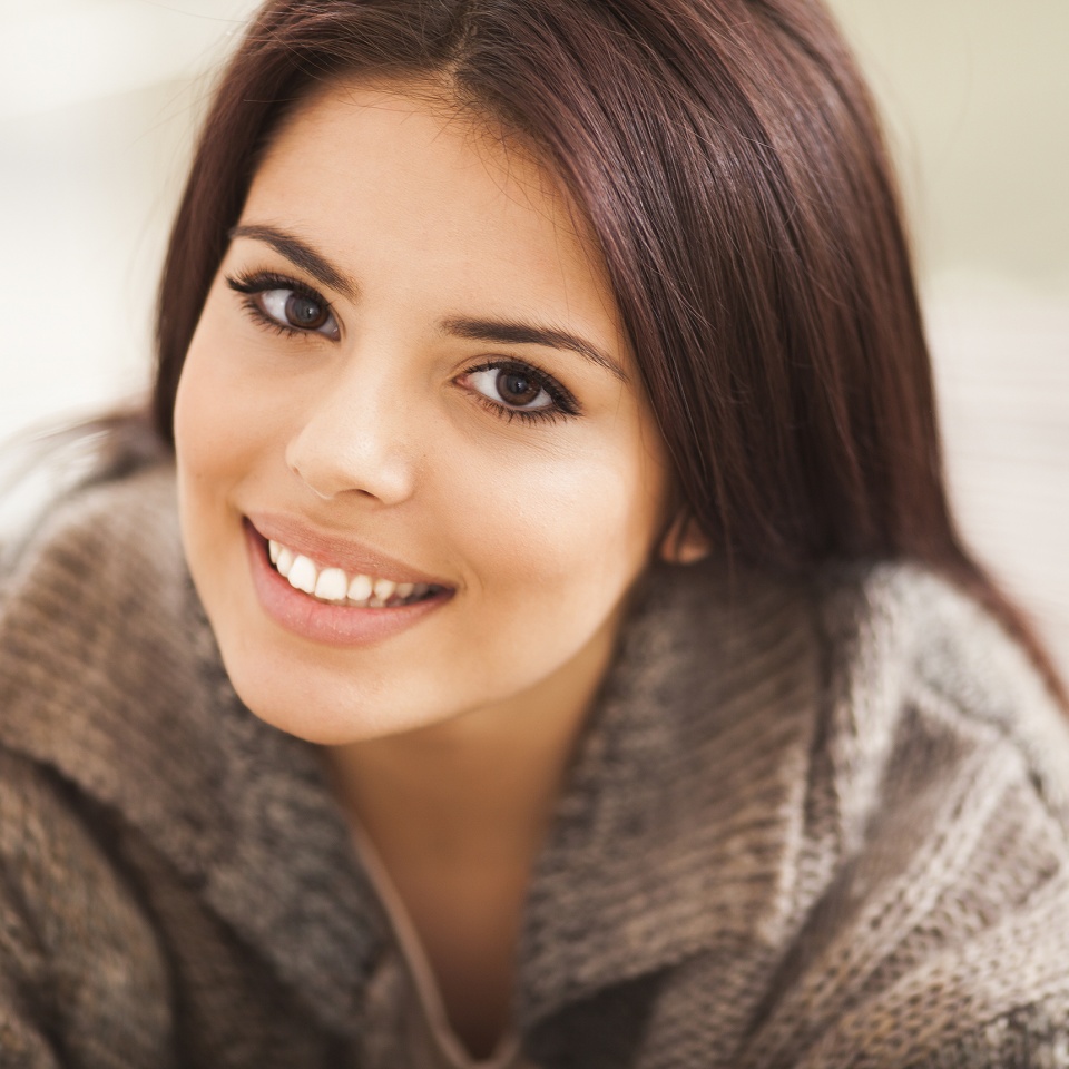 Closeup portrait of a young beautiful lady looking at camera