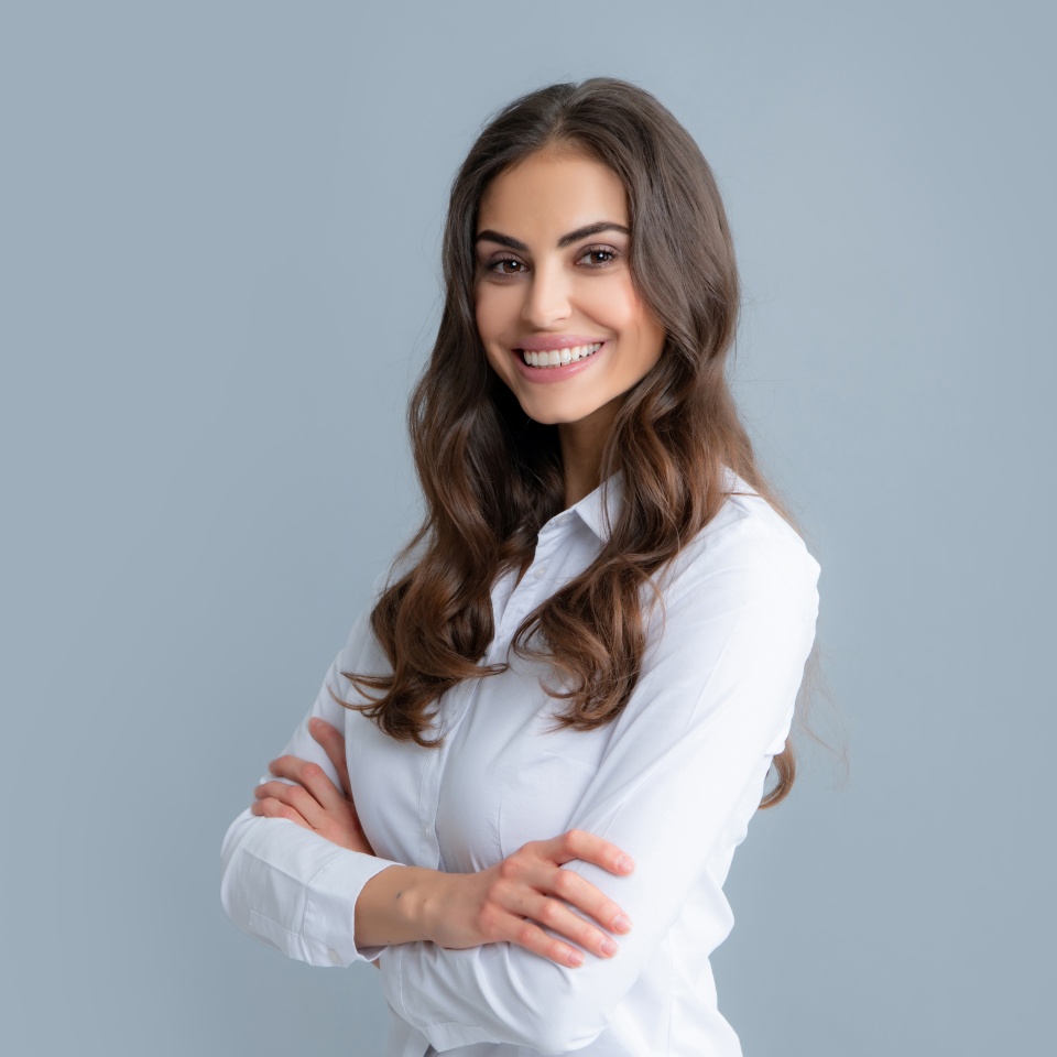Happy smiling woman portrait. Attractive young pretty cheerful girl in casual clothing feeling happy and carefree, isolated gray background.