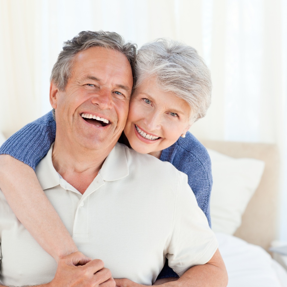 Senior couple looking at the camera at home