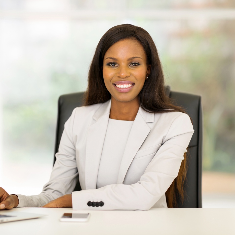 smiling african american business woman using laptop computer
